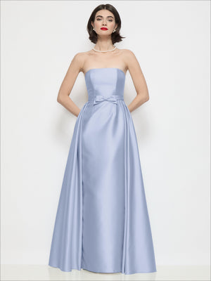 Light blue strapless satin column dress with bow waist and draped overskirt