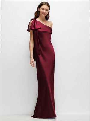 One-shoulder satin maxi dress in deep burgundy with cascading shoulder bow and side slit