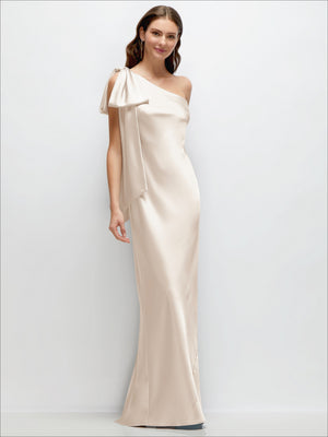 Champagne satin one-shoulder maxi dress with cascading shoulder bow
