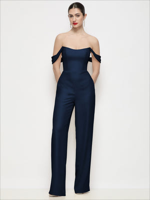Dark navy off-shoulder crepe wide-leg jumpsuit with draped off-shoulder sleeves.