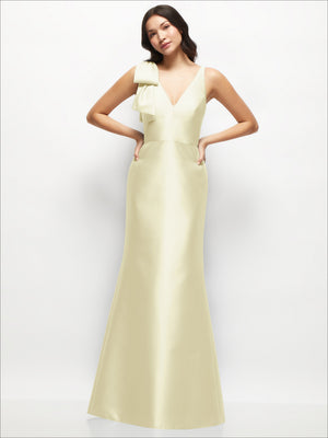 Light yellow satin trumpet dress with deep V-neck and one-shoulder cascading bow, front