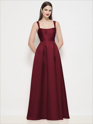 Burgundy satin maxi dress with shaped straps and pleated skirt, fitted bodice.