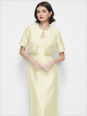 Light yellow cropped satin jacket with jewel neckline and short sleeves, front pocket seams
