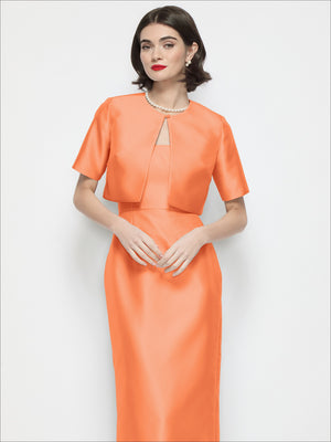 Orange cropped satin jacket with jewel neckline, short sleeves, and front placket detail