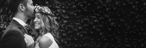 Black-and-white photograph of a wedding couple embracing.